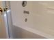 Clean white bathtub with chrome fixtures and a convenient grab bar at 4612 Waterbell Ln, Waxhaw, NC 28173