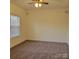 A cozy bedroom is enhanced by natural light, neutral walls, and carpeted floors at 4612 Waterbell Ln, Waxhaw, NC 28173