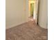 Cozy bedroom with neutral carpet and a doorway leading to another room at 4612 Waterbell Ln, Waxhaw, NC 28173