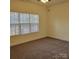 This bedroom features neutral walls, neutral carpet, and a large bright window at 4612 Waterbell Ln, Waxhaw, NC 28173