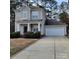Traditional two-story home with neutral siding, white trim, black front door and a two car garage at 4612 Waterbell Ln, Waxhaw, NC 28173