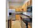 Well-equipped kitchen with stainless steel appliances and wood cabinetry at 4612 Waterbell Ln, Waxhaw, NC 28173