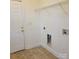 Functional laundry room with tiled floors, shelving, and washer/dryer hookups at 4612 Waterbell Ln, Waxhaw, NC 28173