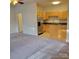 Open living space with carpet, leading to a kitchen featuring stainless steel appliances and wood cabinetry at 4612 Waterbell Ln, Waxhaw, NC 28173