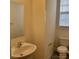 Bright powder room featuring a pedestal sink, toilet, mirror, and window; clean and well-lit space at 4612 Waterbell Ln, Waxhaw, NC 28173