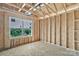 Unfinished bedroom shows the wall and ceiling construction, framing of a closet, and a window at 5005 County Home Rd, Conover, NC 28613