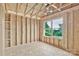 Unfinished bedroom shows the wall and ceiling construction, framing of a closet, and a window at 5005 County Home Rd, Conover, NC 28613