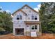 Two-story home under construction showing wrap, windows, and porch in a wooded setting with a blue sky at 5005 County Home Rd, Conover, NC 28613