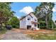 New two-story home featuring protective wrap with landscaping incomplete, surrounded by trees at 5005 County Home Rd, Conover, NC 28613