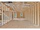 Unfinished living room shows the wall and ceiling construction, window, and exterior door at 5005 County Home Rd, Conover, NC 28613