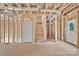 Unfinished living room showing wall and ceiling construction with stairs to upper level at 5005 County Home Rd, Conover, NC 28613