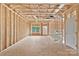 Unfinished living room shows the wall and ceiling construction, window, and exterior door at 5005 County Home Rd, Conover, NC 28613