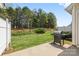 A spacious backyard with a well-maintained lawn and an outdoor grill on the patio at 5959 Pale Moss Ln, Charlotte, NC 28269