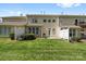 A spacious backyard with green grass and a back patio featuring a grill at 5959 Pale Moss Ln, Charlotte, NC 28269