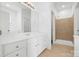 Bathroom features a double vanity, shower, and neutral tile flooring at 5959 Pale Moss Ln, Charlotte, NC 28269