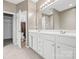 Well-lit bathroom with double vanity, granite countertop, and tile flooring at 5959 Pale Moss Ln, Charlotte, NC 28269