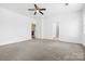 Spacious bedroom showcases a ceiling fan, carpeted floor, and access to other rooms at 5959 Pale Moss Ln, Charlotte, NC 28269