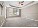 Bright, carpeted bedroom with trey ceiling, ceiling fan, and lots of natural light at 5959 Pale Moss Ln, Charlotte, NC 28269