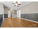 Large bonus room showcases wood floors, paneling, ceiling fan, and access to more rooms at 5959 Pale Moss Ln, Charlotte, NC 28269