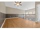 Spacious bonus room features dark paneled walls, railing, and natural light at 5959 Pale Moss Ln, Charlotte, NC 28269