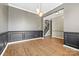 Open dining area featuring modern lighting, decorative molding, and hardwood flooring at 5959 Pale Moss Ln, Charlotte, NC 28269
