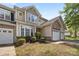 Attractive townhome with stone details, a one-car garage, and neatly maintained landscaping at 5959 Pale Moss Ln, Charlotte, NC 28269