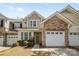 Charming townhome with stone accents, a one-car garage, and a well-manicured front yard at 5959 Pale Moss Ln, Charlotte, NC 28269