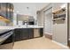 Modern kitchen features stainless steel appliances, dark cabinetry, and white countertops at 5959 Pale Moss Ln, Charlotte, NC 28269