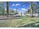Large backyard with mature trees, providing shade and privacy for outdoor enjoyment at 6823 City View Dr, Charlotte, NC 28212