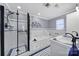 Bright bathroom featuring a shower, a jacuzzi tub, and blue and white tile accents at 6823 City View Dr, Charlotte, NC 28212