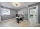 This bedroom offers ample natural light and neutral tones and features an office setup and closet at 6823 City View Dr, Charlotte, NC 28212