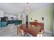 Bright dining area featuring a modern chandelier, wood furniture, and adjacent kitchen view at 6823 City View Dr, Charlotte, NC 28212