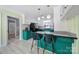 Well-appointed kitchen with custom green island seating, black appliances, and bright lighting at 6823 City View Dr, Charlotte, NC 28212