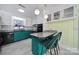 Charming kitchen featuring unique green cabinetry and breakfast bar seating at 6823 City View Dr, Charlotte, NC 28212
