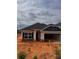 New construction home featuring stone accents, a dark roof, and a two-car garage at 713 Inwood Hill Dr # 96, Gastonia, NC 28056