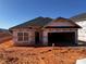 View of a new construction home with black roof and siding barrier ready for exterior finishing at 713 Inwood Hill Dr # 96, Gastonia, NC 28056