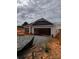 New construction home with white siding, black roof, and an open garage door at 713 Inwood Hill Dr # 96, Gastonia, NC 28056