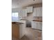 Bright kitchen featuring white cabinets, an island, and a large window, ready to be finished and personalized at 713 Inwood Hill Dr # 96, Gastonia, NC 28056