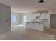 Spacious kitchen with white cabinets, an island, and abundant natural light, ready for personalization at 713 Inwood Hill Dr # 96, Gastonia, NC 28056