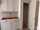 Close-up of stylish white kitchen cabinetry and an open doorway leading to a pantry or storage area at 713 Inwood Hill Dr # 96, Gastonia, NC 28056