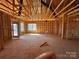 Unfinished living room showcases the framing of the interior with windows and a door at 713 Inwood Hill Dr # 96, Gastonia, NC 28056