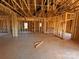 Unfinished living room showcases the framing of the interior with windows and a door at 713 Inwood Hill Dr # 96, Gastonia, NC 28056