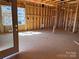 An unfinished living room showcases the framing, window, and door installation at 713 Inwood Hill Dr # 96, Gastonia, NC 28056
