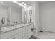 Bathroom with double sinks, granite countertop, large mirror, and classic white cabinetry at 7172 Indigo Way, Denver, NC 28037