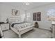 Cozy bedroom features a neutral color scheme, a comfortable queen bed, and bright, natural light at 7172 Indigo Way, Denver, NC 28037