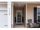 Inviting front door entry with charming details and decorative plants creates a warm and welcoming atmosphere at 7172 Indigo Way, Denver, NC 28037