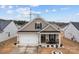 Charming home with a well-manicured front yard, inviting porch, and two-car garage at 7172 Indigo Way, Denver, NC 28037