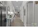Spacious hallway with modern decor, neutral paint and updated flooring leads to the home's living spaces at 7172 Indigo Way, Denver, NC 28037