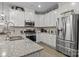 Modern kitchen featuring stainless steel appliances, granite countertops, and ample cabinet space at 7172 Indigo Way, Denver, NC 28037