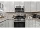 A well-equipped kitchen featuring stainless steel appliances, granite countertops, and white cabinetry at 7172 Indigo Way, Denver, NC 28037